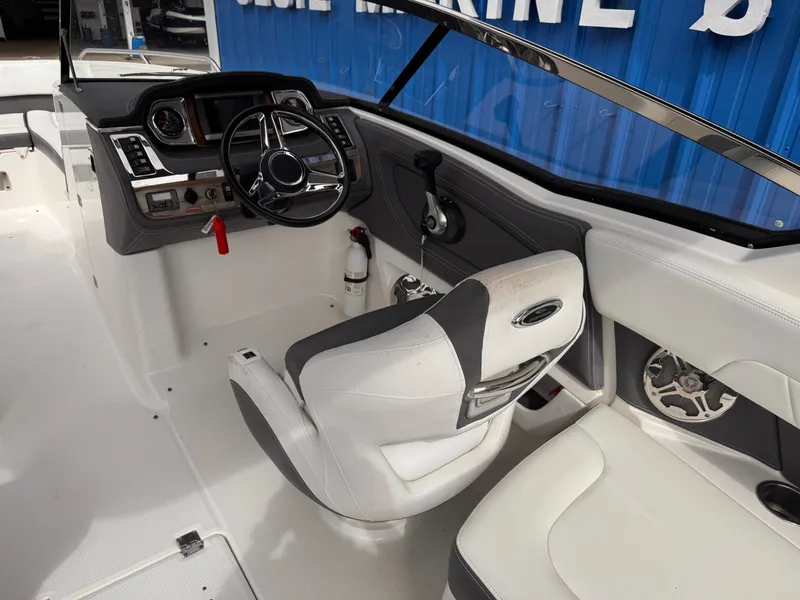 Slide: The Image of 2013 Chaparral 257 SSX boat interior seating with cup holders and speaker. - 31