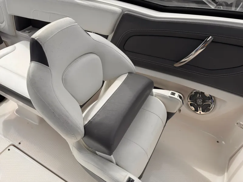 Slide: The Image of 2013 Chaparral 257 SSX boat interior with white seating and speaker. - 35