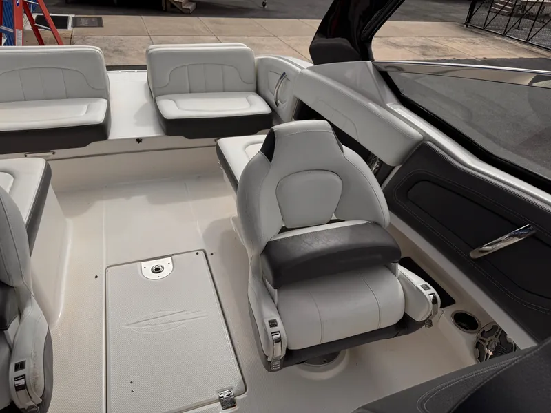 Slide: The Image of 2013 Chaparral 257 SSX boat interior with white seating and steering wheel. - 38