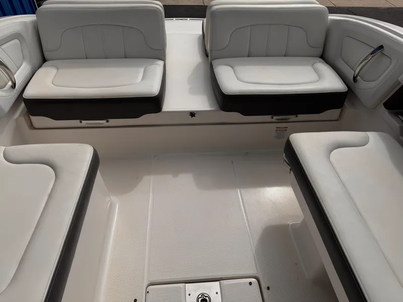 Slide: The Image of 2013 Chaparral 257 SSX boat interior with white and gray seating arrangement. - 39