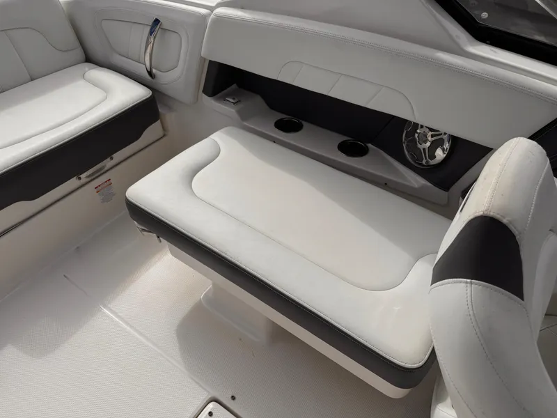Slide: The Image of 2013 Chaparral 257 SSX boat interior with white cushioned seating. - 40