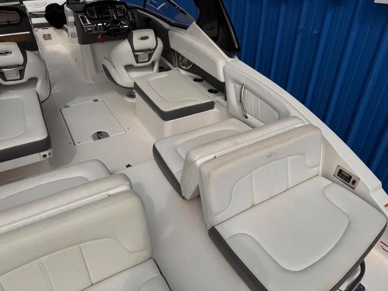 Slide: The Image of Interior seating of 2013 Chaparral 257 SSX boat with white upholstery and cup holders. - 41