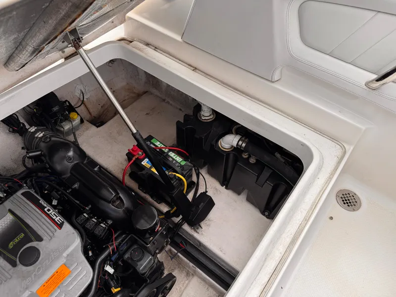 Slide: The Image of Engine compartment of 2013 Chaparral 257 SSX boat, showing battery and fire extinguisher. - 47