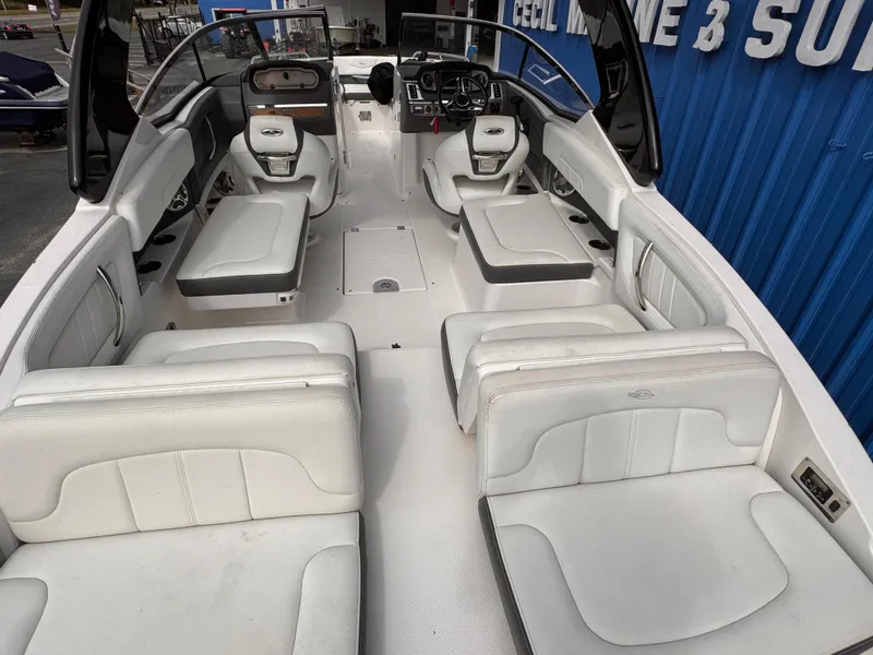 Slide: The Image of Covered 2013 Chaparral 257 SSX boat outside a blue building. - 5