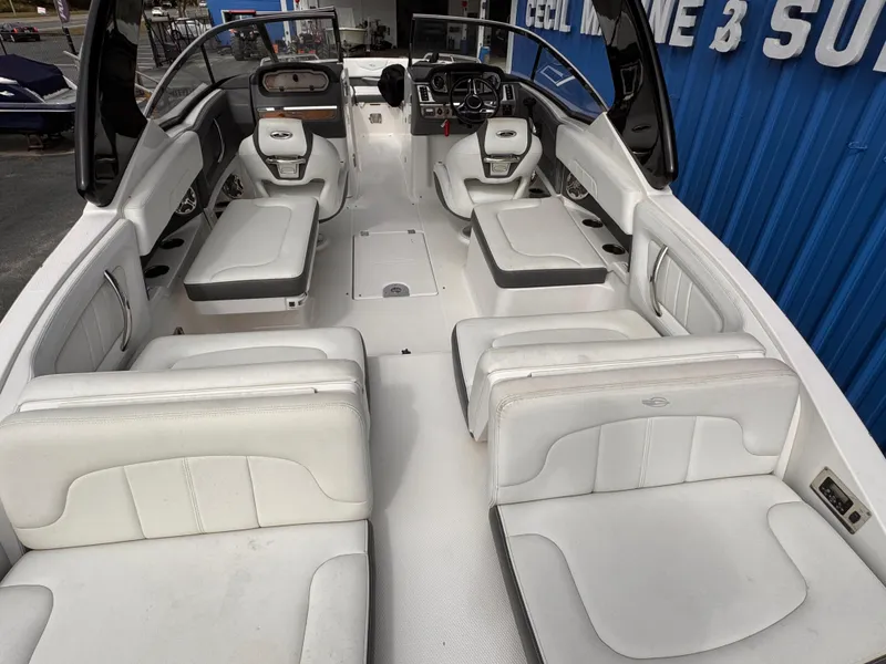Slide: The Image of 2013 Chaparral 257 SSX boat interior with white seating and modern dashboard. - 6