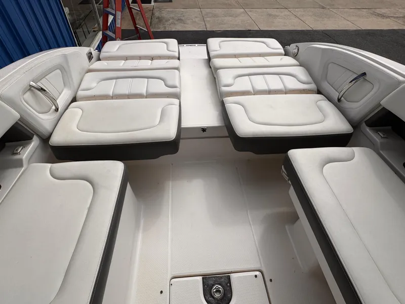 Slide: The Image of 2013 Chaparral 257 SSX boat interior with white seating and dashboard. - 7