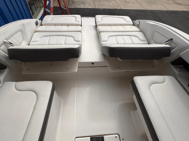 Slide: The Image of 2013 Chaparral 257 SSX boat interior with white cushioned seating. - 8