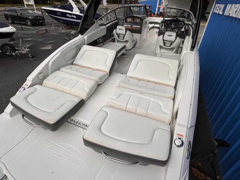 Slide: The Image of 2013 Chaparral 257 SSX boat interior with white cushioned seating. - 9