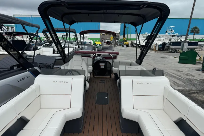 Slide: The Image of 2025 Manitou 24' Explore Switchback pontoon boat with spacious seating and sleek design. - 4