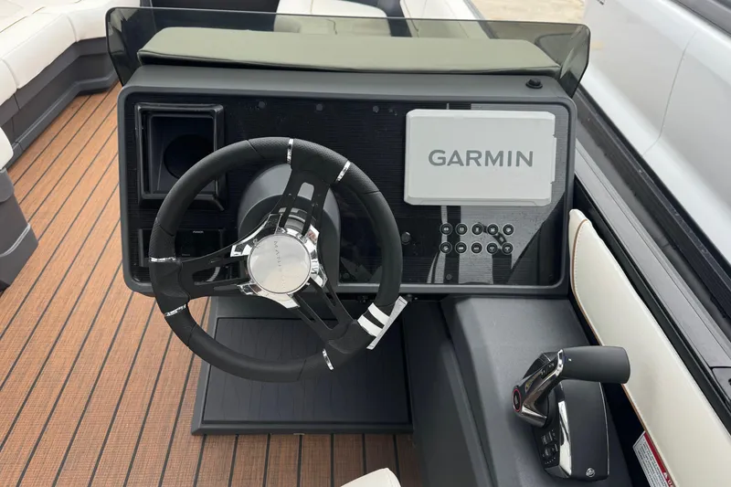 Slide: The Image of 2025 Manitou 24' Explore Switchback boat dashboard with Garmin navigation system. - 6