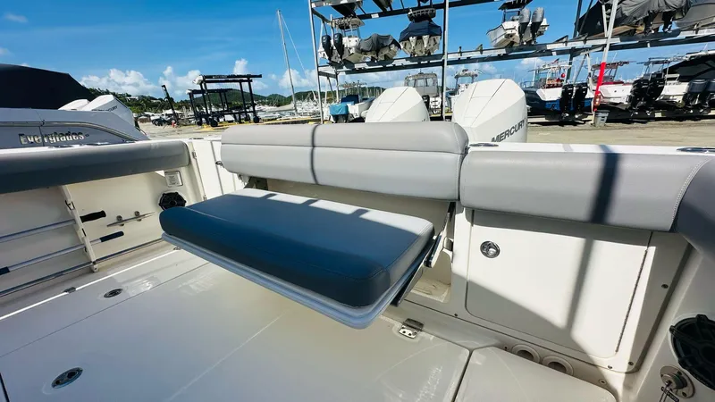 Slide: The Image of 2023 Boston Whaler 330 Outrage boat interior with seating and storage. - 16