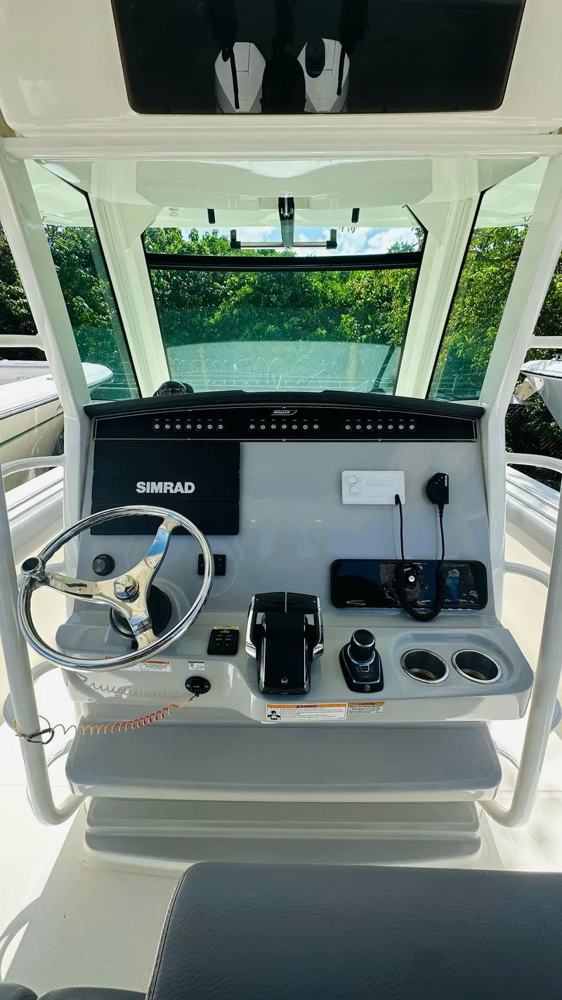 Slide: The Image of 2023 Boston Whaler 330 Outrage helm with Simrad electronics and modern controls. - 19