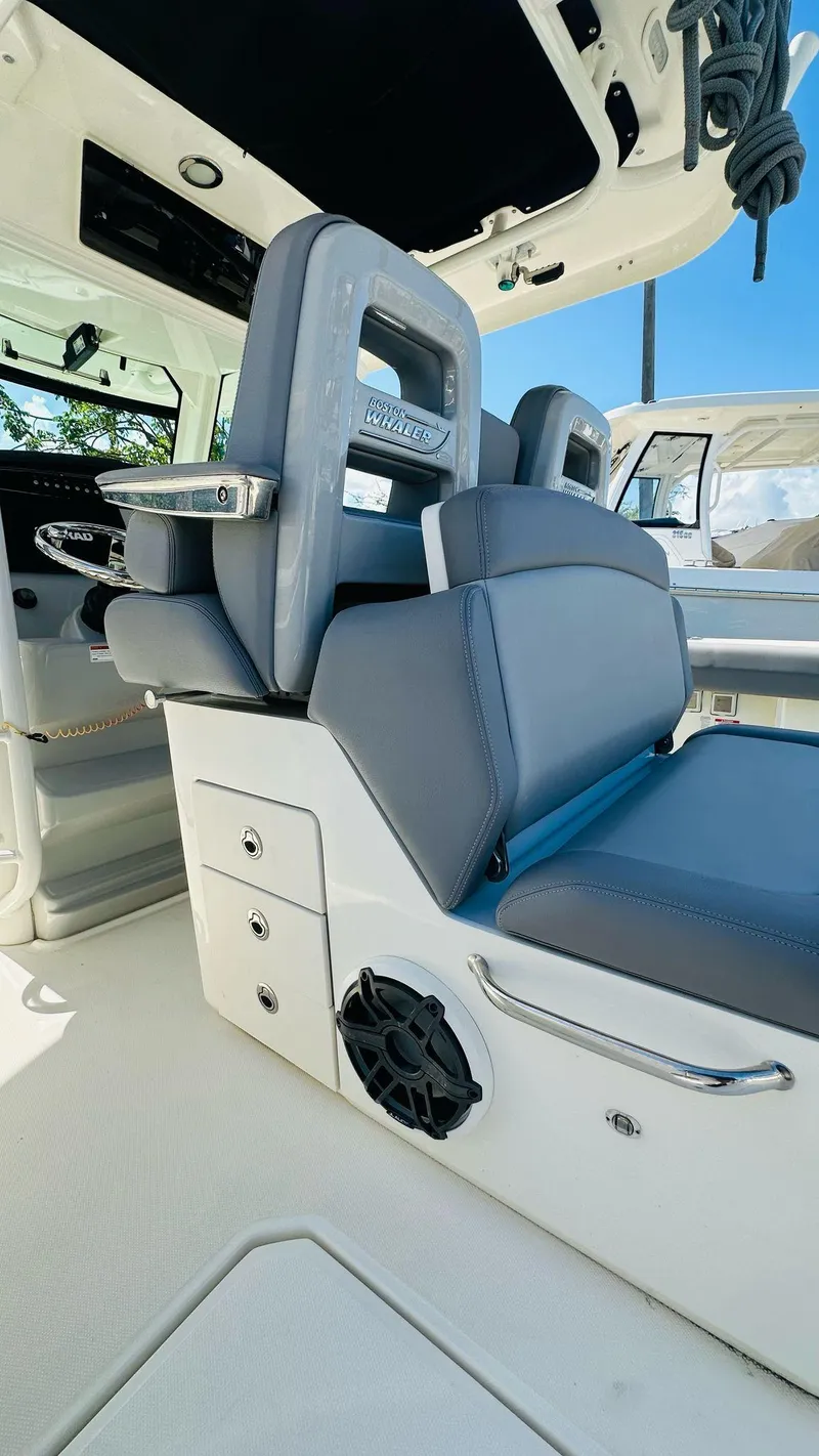 Slide: The Image of 2023 Boston Whaler 330 Outrage interior with sleek seating and modern design. - 21