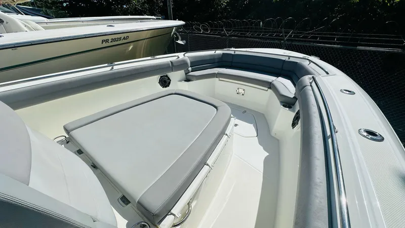 Slide: The Image of 2023 Boston Whaler 330 Outrage boat interior with cushioned seating and sleek design. - 22