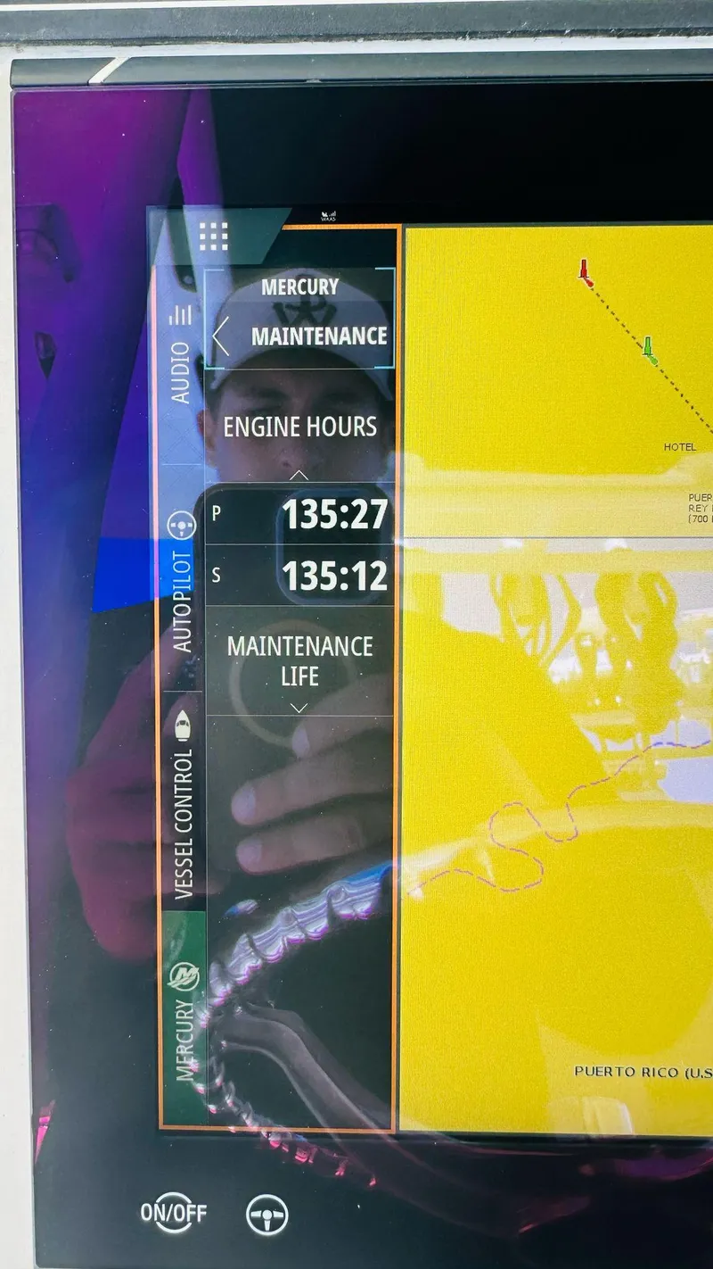Slide: The Image of Close-up of a 2023 Boston Whaler 330 Outrage engine hours display screen. - 26