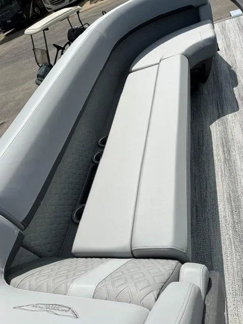 Slide: The Image of 2025 Veranda Relax VR22RC boat interior with sleek, modern seating and cup holders. - 13