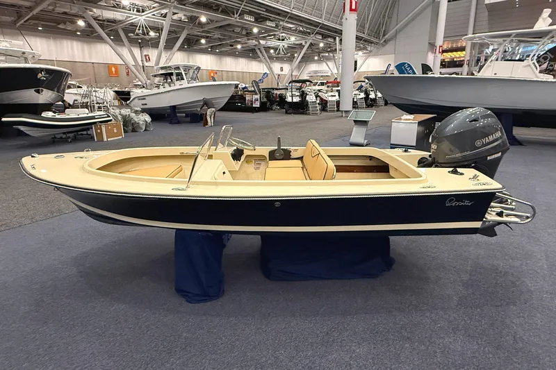 The Image of 2025 Rossiter 14 boat displayed indoors, featuring a Yamaha outboard motor. - 1