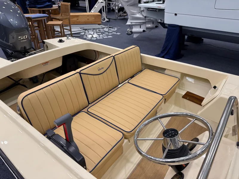 Slide: The Image of 2025 Rossiter 14 boat interior with tan seating and steering wheel. - 14