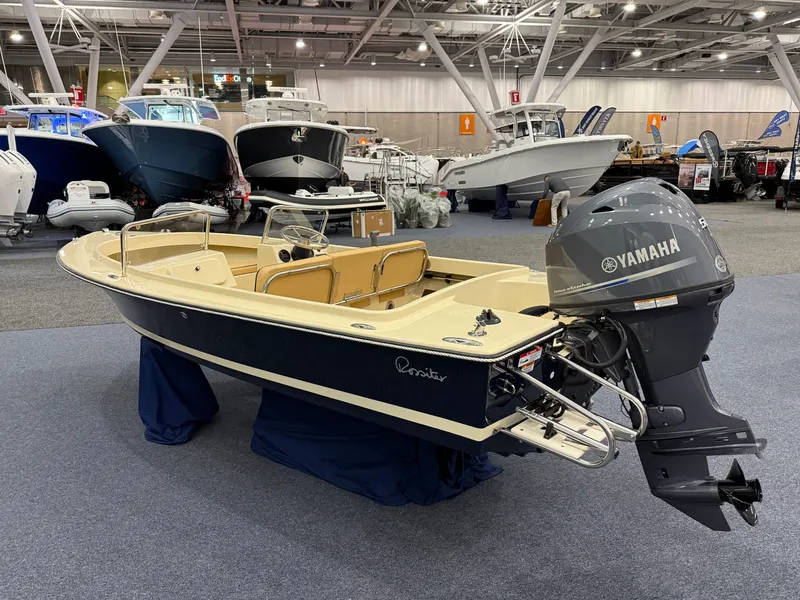 Slide: The Image of 2025 Rossiter 14 boat with Yamaha engine displayed at a boat show. - 3