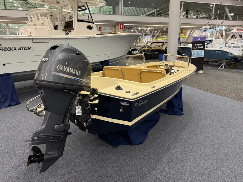 Slide: The Image of 2025 Rossiter 14 boat with Yamaha engine displayed at a boat show. - 5
