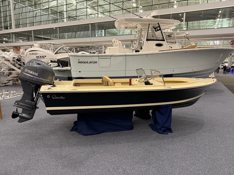 Slide: The Image of 2025 Rossiter 14 boat with Yamaha outboard motor on display indoors. - 6
