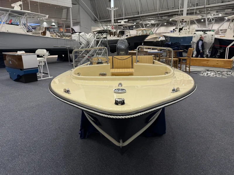 Slide: The Image of 2025 Rossiter 14 boat displayed at an indoor boat show. - 8