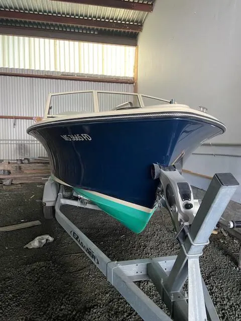 Slide: The Image of 2018 Rossiter 20 Coastal Cruiser boat on trailer in storage facility. - 14