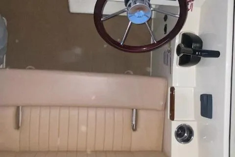 Slide: The Image of 2018 Rossiter 20 Coastal Cruiser interior with steering wheel and controls. - 5