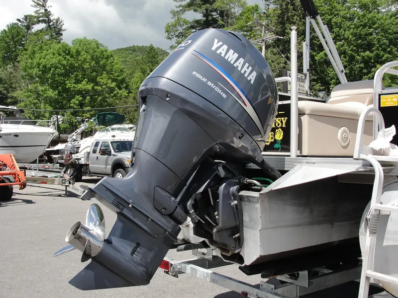 Slide: The Image of 2012 Veranda RFL2575V with Yamaha outboard motor in a marina setting. - 11