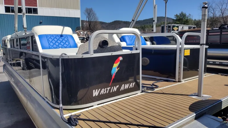 Slide: The Image of Pontoon boat Veranda RFL2575V 2012 with blue seating and "Wastin' Away" text on the side. - 30