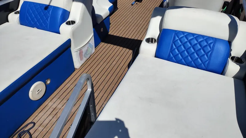 Slide: The Image of Veranda RFL2575V 2012 boat interior with blue and white seating, wooden deck. - 31