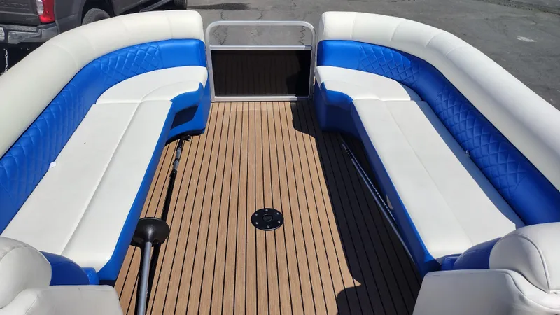 Slide: The Image of 2012 Veranda RFL2575V boat interior with blue and white seating, wooden deck. - 39