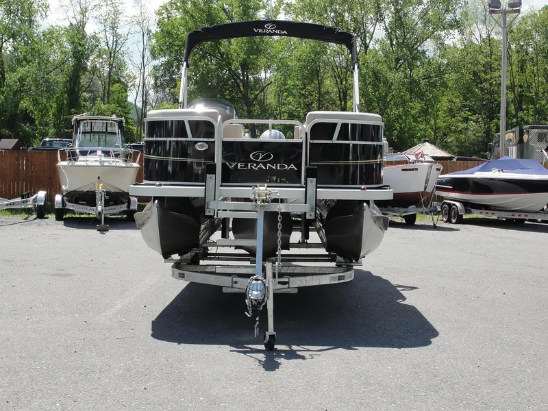 Slide: The Image of 2012 Veranda RFL2575V pontoon boat on trailer, parked outdoors. - 4