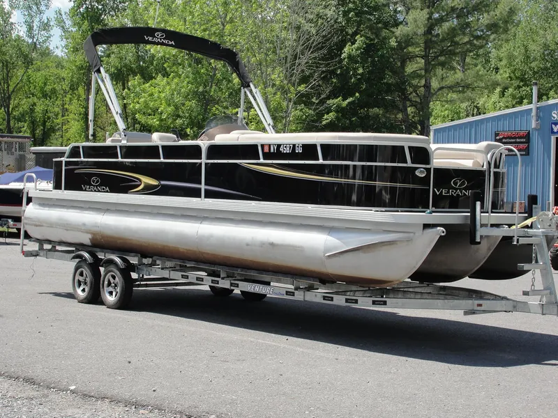 Slide: The Image of 2012 Veranda RFL2575V pontoon boat on trailer, parked outdoors. - 5
