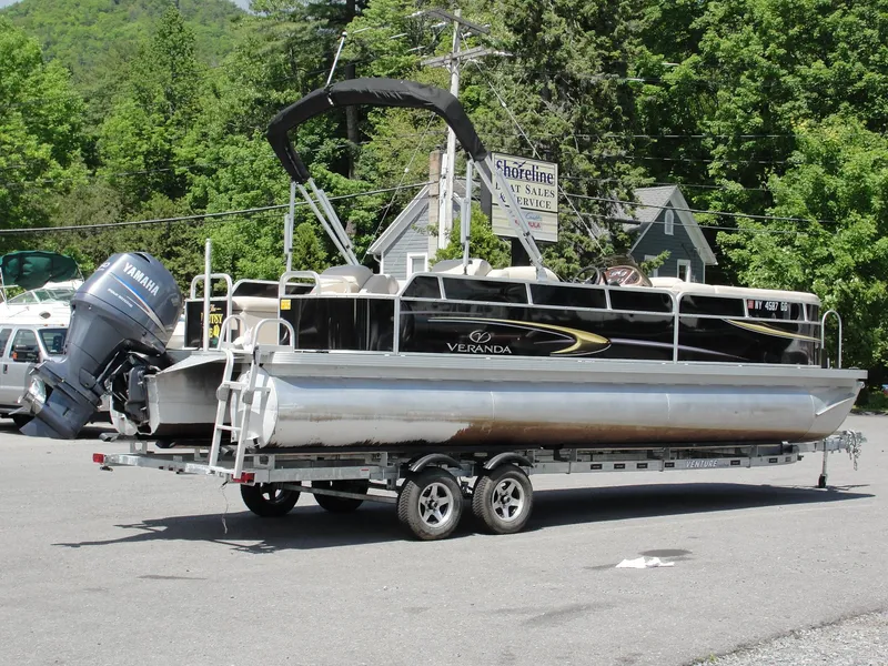 Slide: The Image of 2012 Veranda RFL2575V pontoon boat on trailer, parked outdoors. - 7