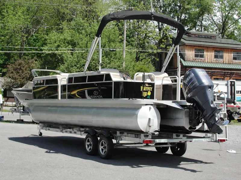 Slide: The Image of 2012 Veranda RFL2575V pontoon boat on trailer, parked outdoors. - 9