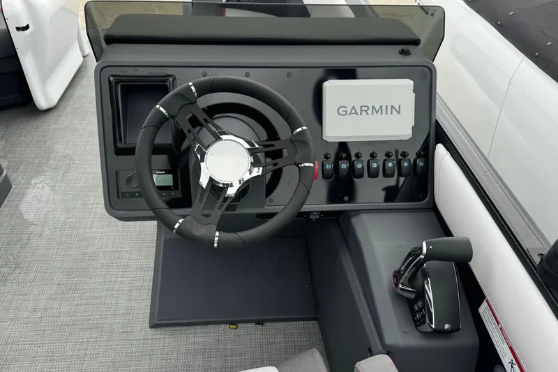 Slide: The Image of 2025 Manitou 22' Cruise Switchback dashboard with Garmin navigation system. - 5