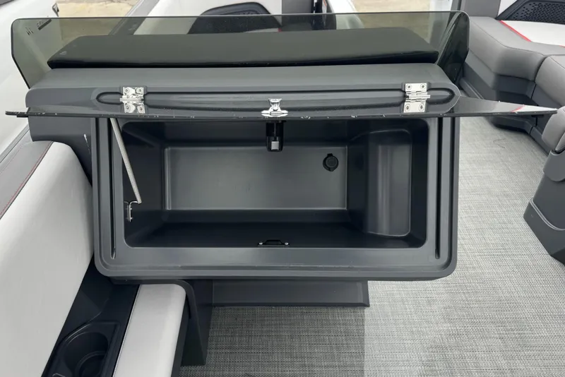 Slide: The Image of 2025 Manitou 22' Cruise Switchback storage compartment with open lid, showcasing interior space. - 6