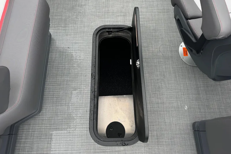 Slide: The Image of 2025 Manitou 22' Cruise Switchback boat interior storage compartment open. - 8