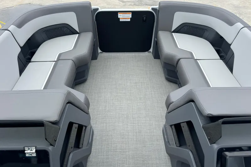 Slide: The Image of 2025 Manitou 22' Cruise Switchback interior with gray seating and flooring. - 2