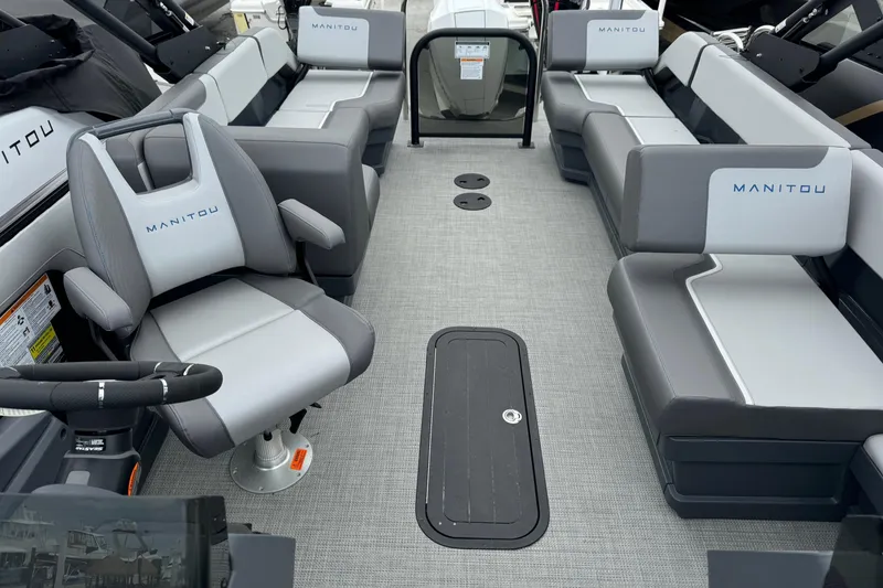 Slide: The Image of 2025 Manitou 22' Cruise Switchback interior with gray seating and steering console. - 4