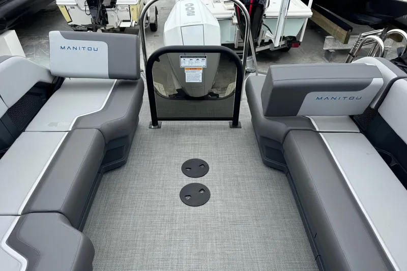 Slide: The Image of 2025 Manitou 22' Cruise Switchback interior with gray seating and modern design. - 5