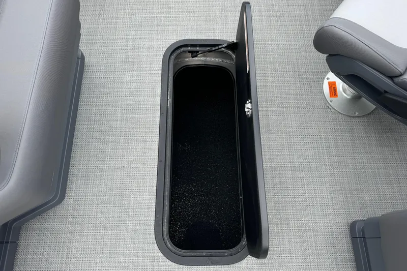 Slide: The Image of Open storage compartment on 2025 Manitou 22' Cruise Switchback boat interior. - 9