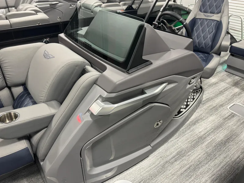 Slide: The Image of 2025 Bennington 25 RSB boat interior with luxurious seating and modern dashboard design. - 12
