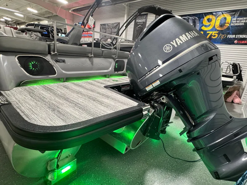 Slide: The Image of 2025 Bennington 25 RSB boat with Yamaha engine, featuring green LED lights and sleek design. - 23