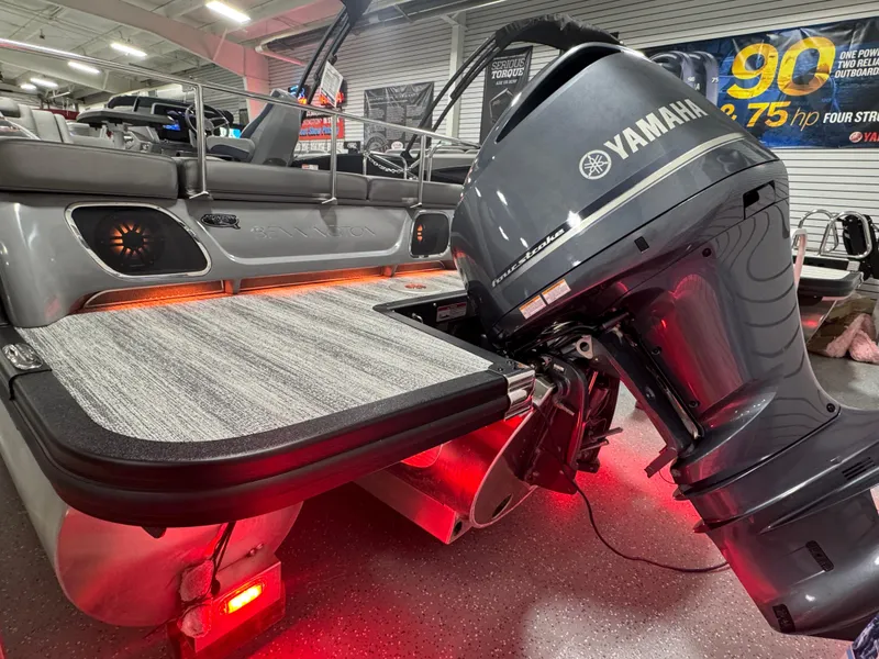 Slide: The Image of 2025 Bennington 25 RSB pontoon boat with Yamaha engine, illuminated deck, and modern design. - 24