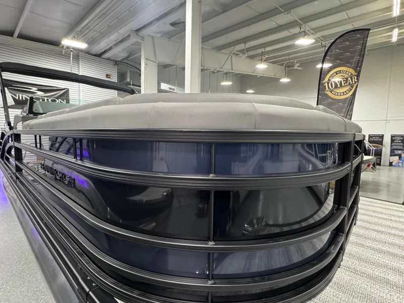 Slide: The Image of 2025 Bennington 25 RSB pontoon boat displayed indoors, showcasing sleek design and modern features. - 4
