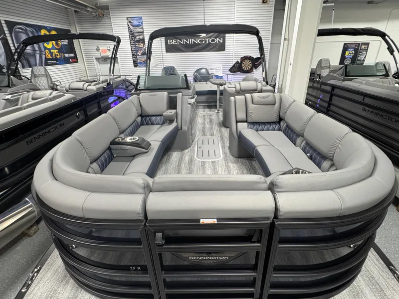Slide: The Image of 2025 Bennington 25 RSB pontoon boat with luxurious seating in showroom display. - 5