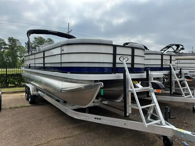 Slide: The Image of 2025 Veranda Vista Sport 25RC pontoon boat on trailer, parked outdoors. - 1