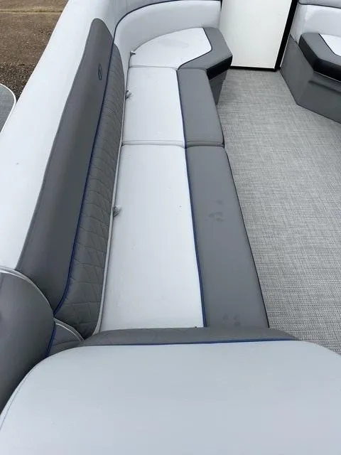 Slide: The Image of 2025 Veranda Vista Sport 25RC boat interior with gray and white seating. - 12
